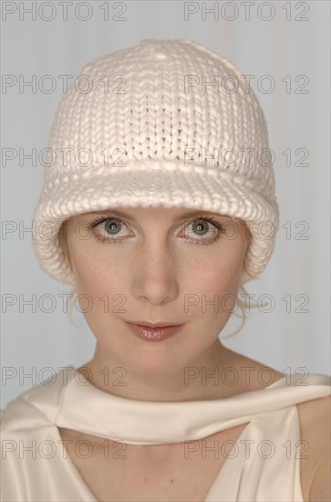 Blond woman with a white woolly hat
