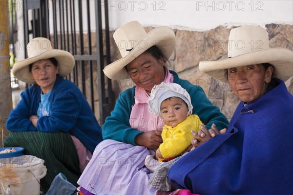 Indigenous street vendors with a child