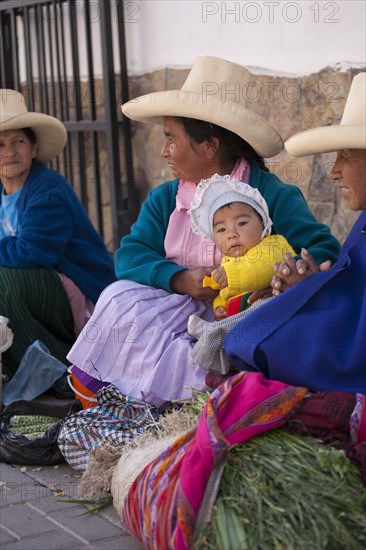 Indigenous street vendors with a child