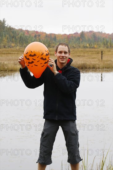 Man holding a Halloween balloon
