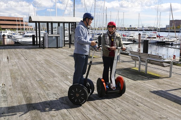 Tourists riding segways round the port