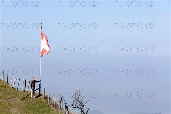 Tourist standing beside a Swiss flag