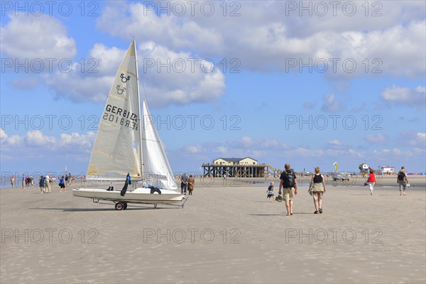 Yacht and stilt house with Strandbar 54 beach club on the beach of St. Peter-Ording