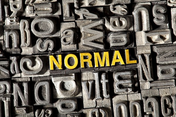 Old lead letters forming the word NORMAL