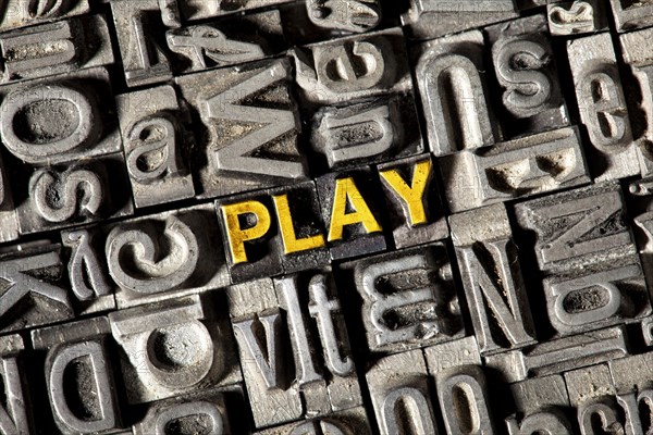 Old lead letters forming the word PLAY