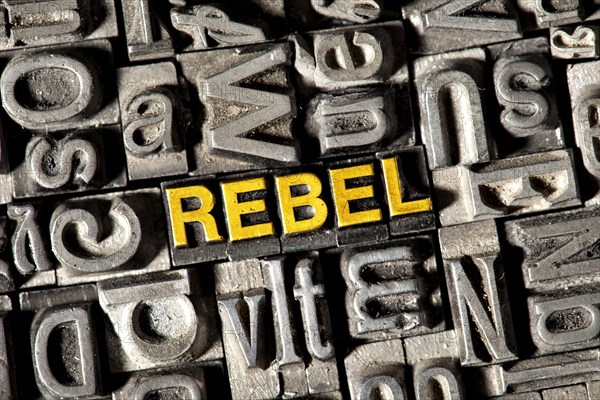 Old lead letters forming the word REBEL