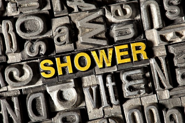 Old lead letters forming the word 'SHOWER'