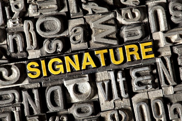 Old lead letters forming the word 'SIGNATURE'