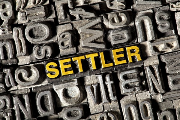 Old lead letters forming the word 'SETTLER'
