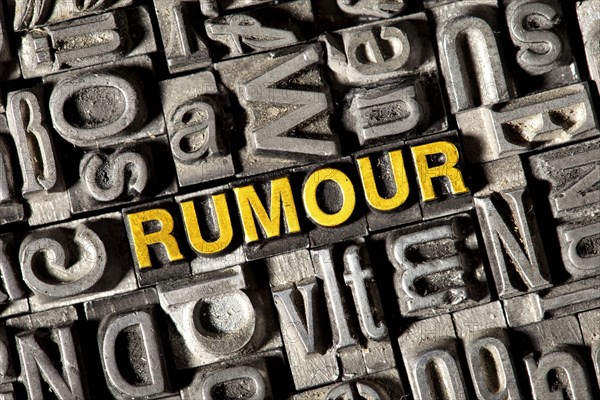Old lead letters forming the word 'RUMOUR'