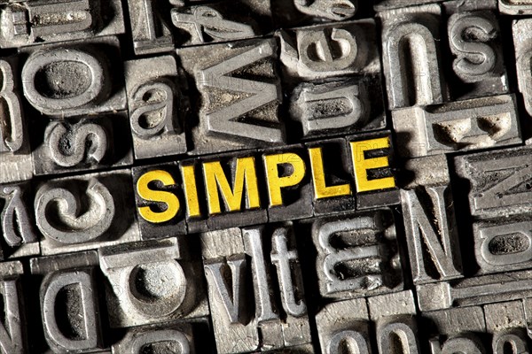 Old lead letters forming the word 'SIMPLE'