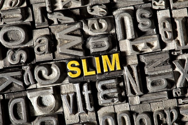 Old lead letters forming the word 'SLIM'