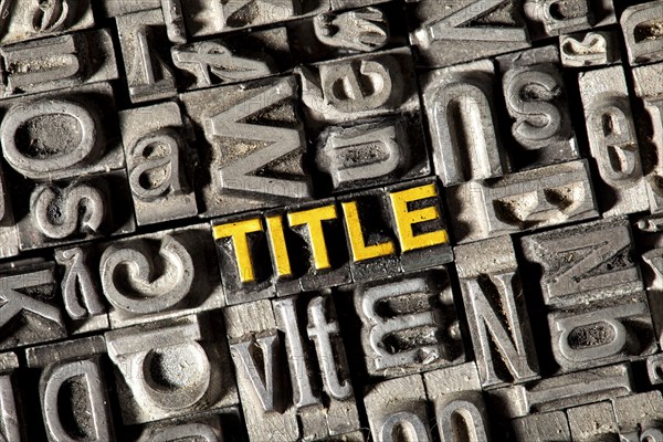 Old lead letters forming the word 'TITLE'