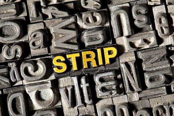 Old lead letters forming the word 'STRIP'