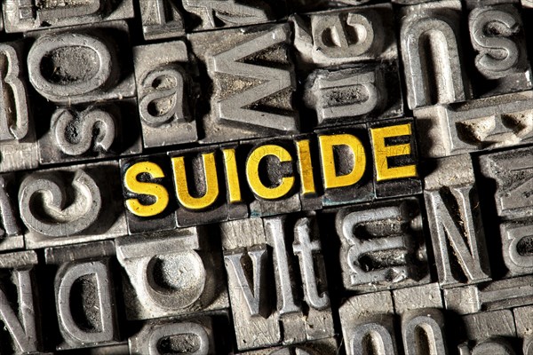 Old lead letters forming the word "SUICIDE"
