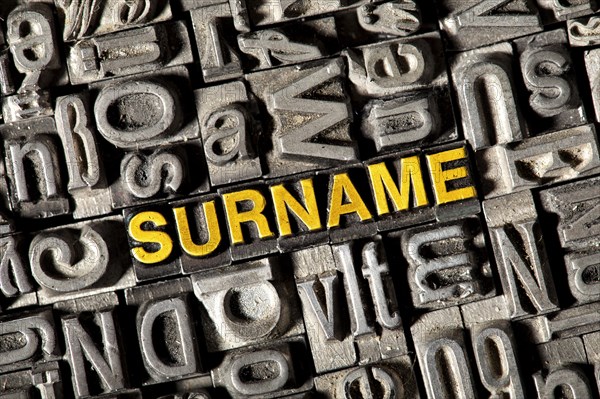 Old lead letters forming the word 'SURNAME'