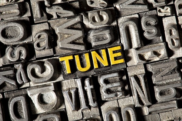 Old lead letters forming the word Tune