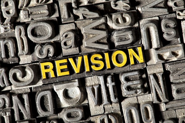 Old lead letters forming the word 'REVISION'