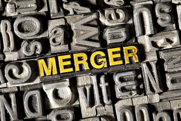 Old lead letters forming the word Merger