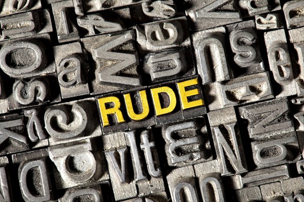 Old lead letters forming the word Rude