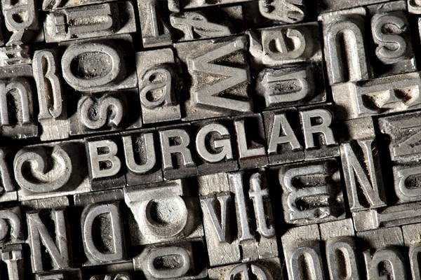 Old lead letters forming the word 'BURGLAR'