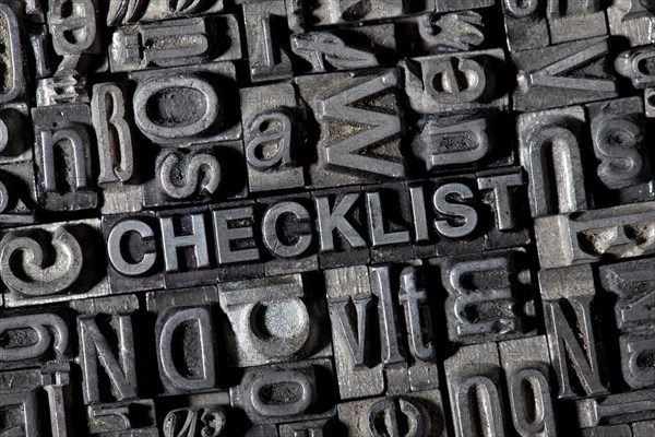 Old lead letters forming the word CHECKLIST