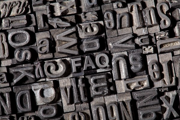 Old lead letters forming the acronym FAQ