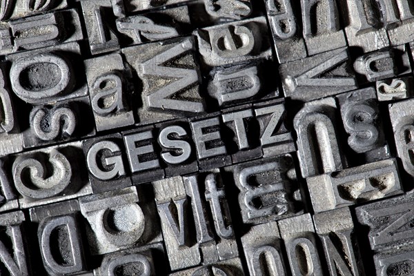 Old lead letters forming the word GESETZ