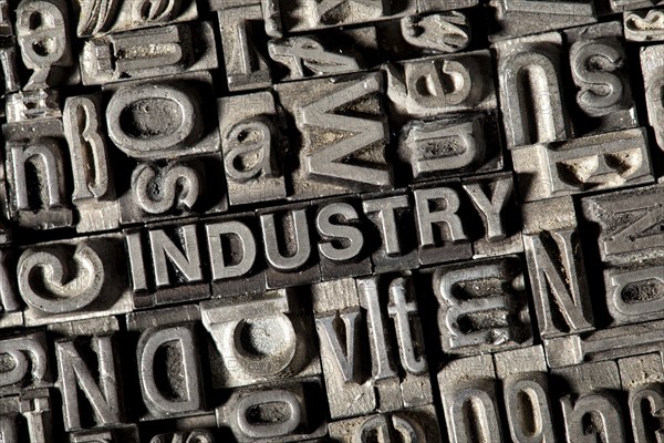Old lead letters forming the word INDUSTRY