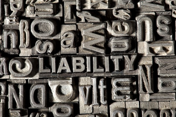Old lead letters forming the word 'LIABILITY'