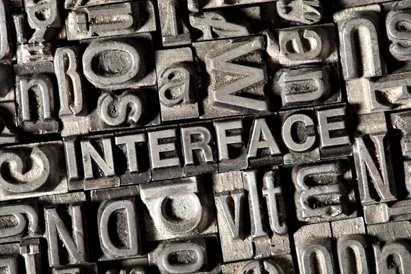 Old lead letters forming the word 'INTERFACE'