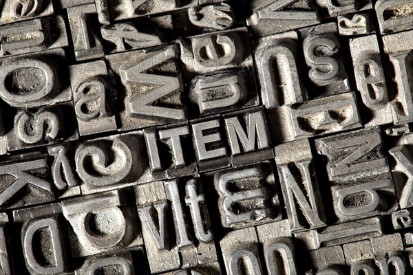 Old lead letters forming the word 'ITEM'