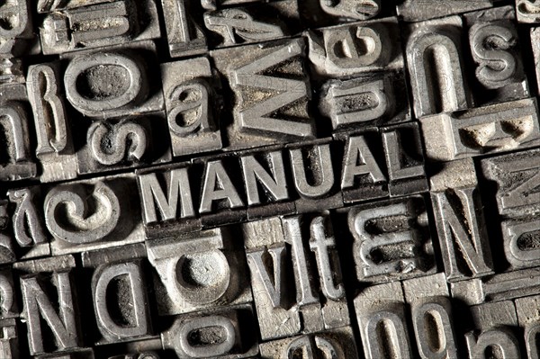 Old lead letters forming the word "MANUAL"