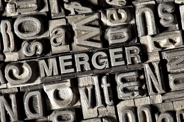 Old lead letters forming the word 'MERGER'