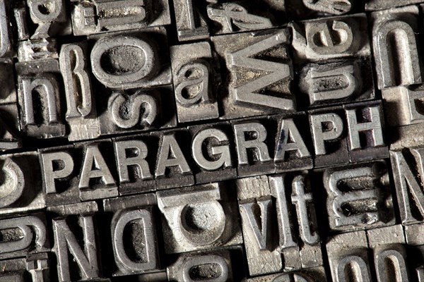 Old lead letters forming the word 'PARAGRAPH'