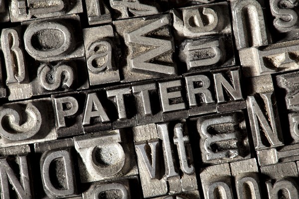 Old lead letters forming the word 'PATTERN'