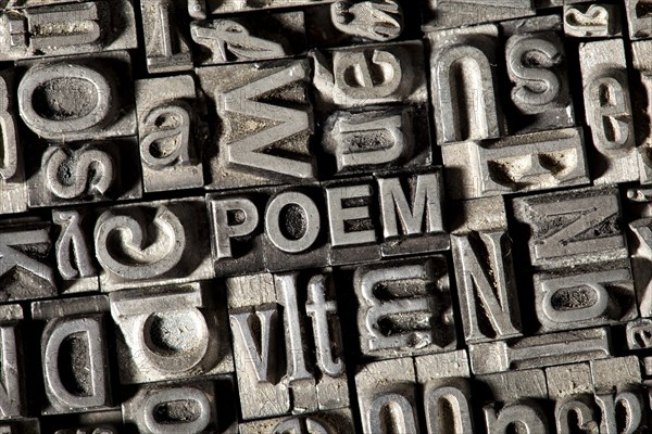 Old lead letters forming the word 'POEM'