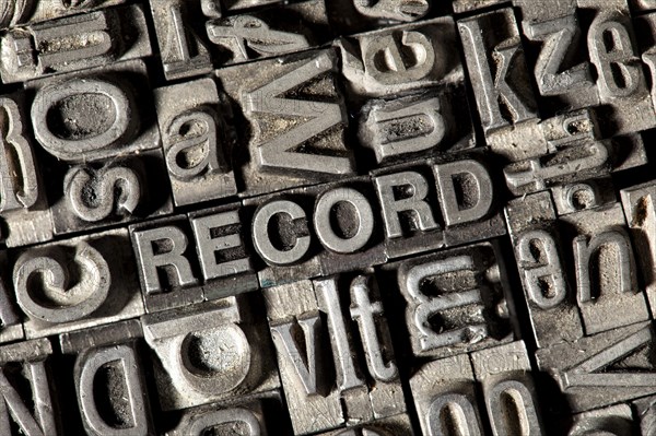 Old lead letters forming the word 'RECORD'