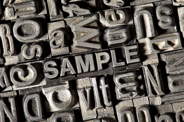 Old lead letters forming the word SAMPLE