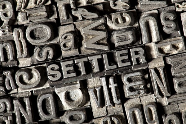 Old lead letters forming the word SETTLER