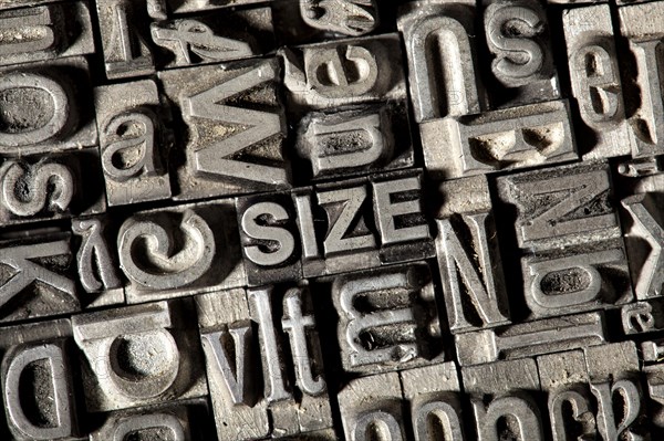 Old lead letters forming the word SIZE