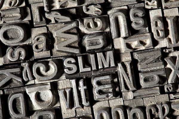 Old lead letters forming the word SLIM
