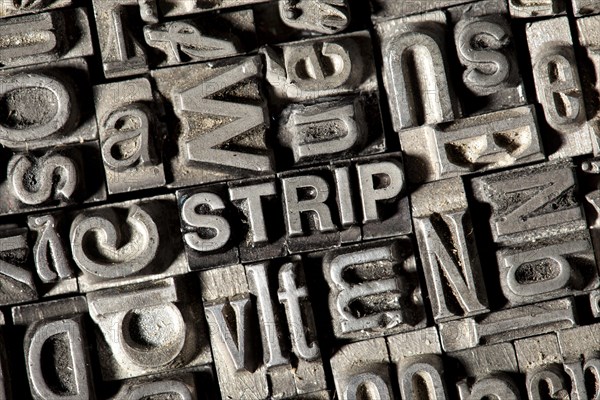Old lead letters forming the word "STRIP"