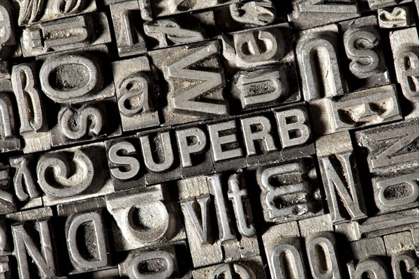 Old lead letters forming the word 'SUPERB'