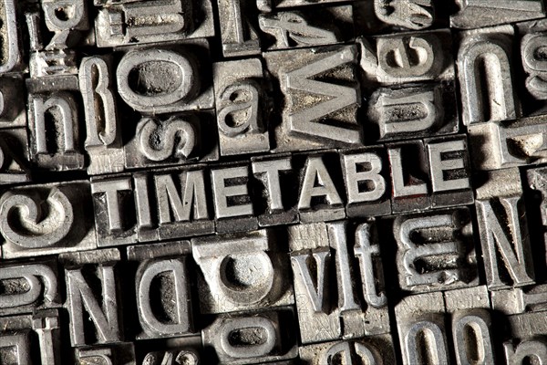 Old lead letters forming the word TIMETABLE