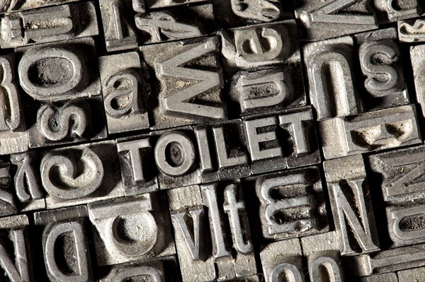 Old lead letters forming the word TOILET