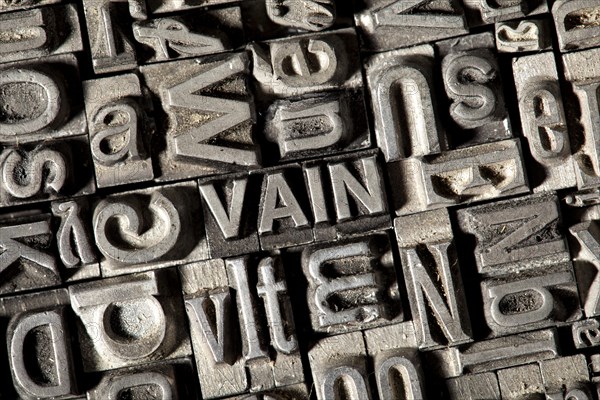 Old lead letters forming the word VAIN