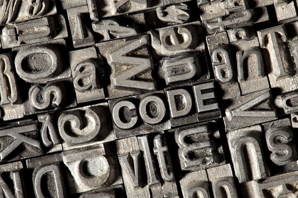 Old lead letters forming the word CODE