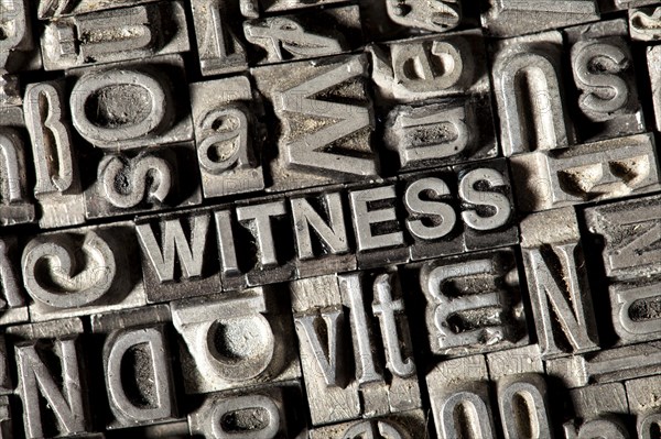 Old lead letters forming the word WITNESS