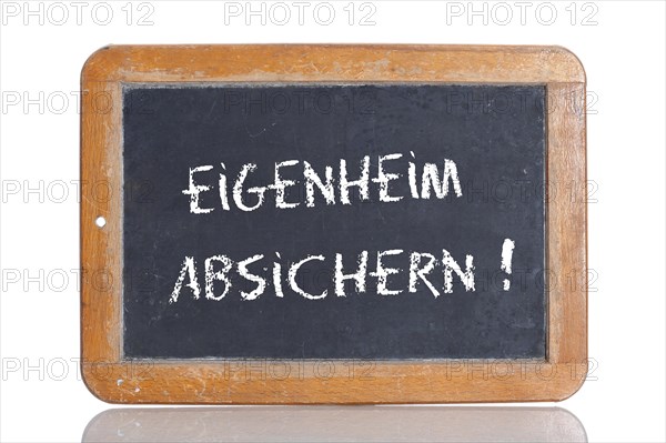 Old school blackboard with the words EIGENHEIM ABSICHERN!
